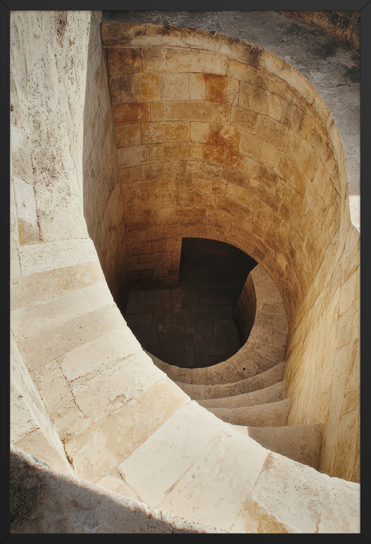 The Descent - Minimalist ivory spiral staircase wall art poster — poster in a black frame, front view