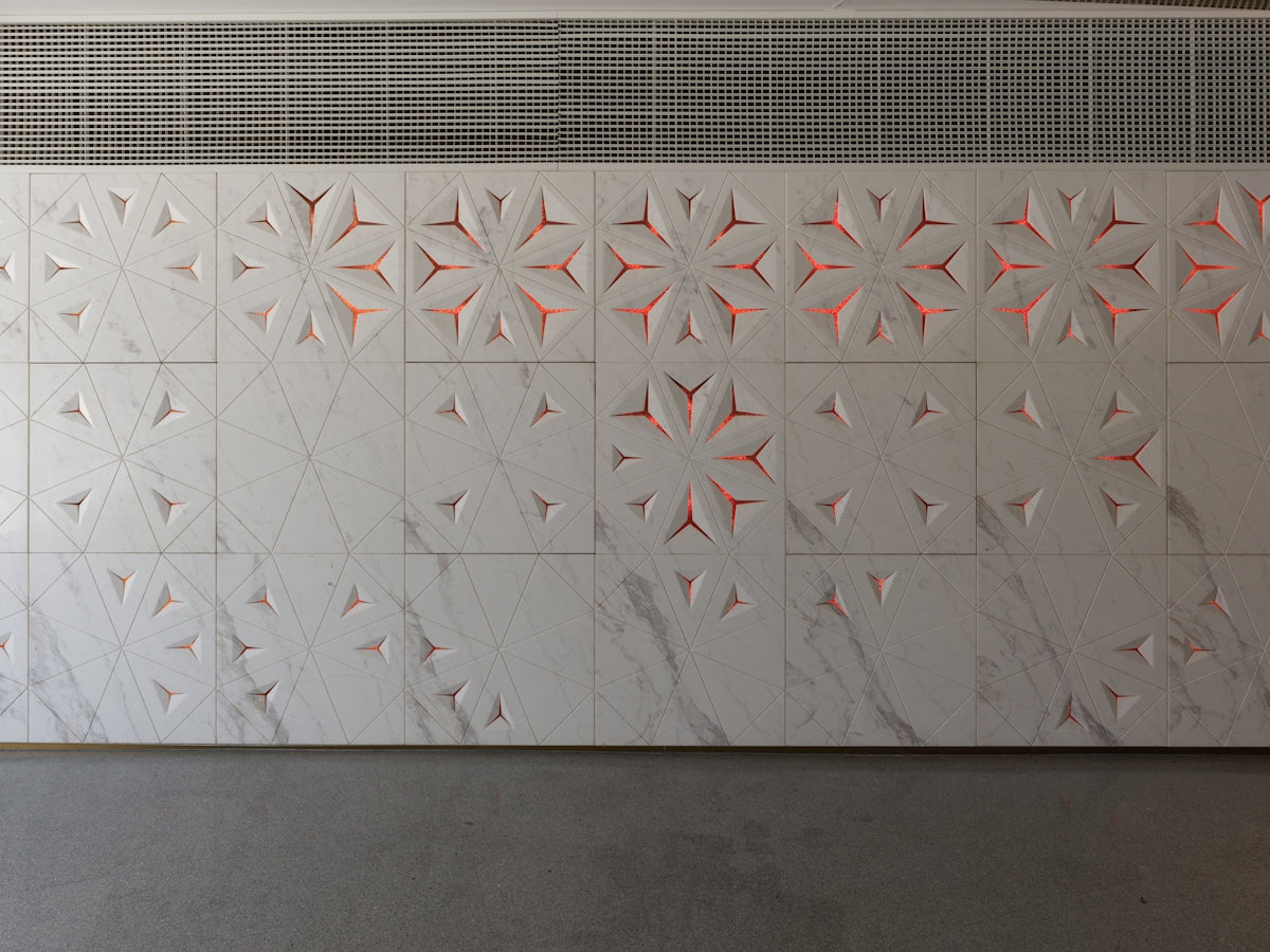 A white wall with a pattern on it