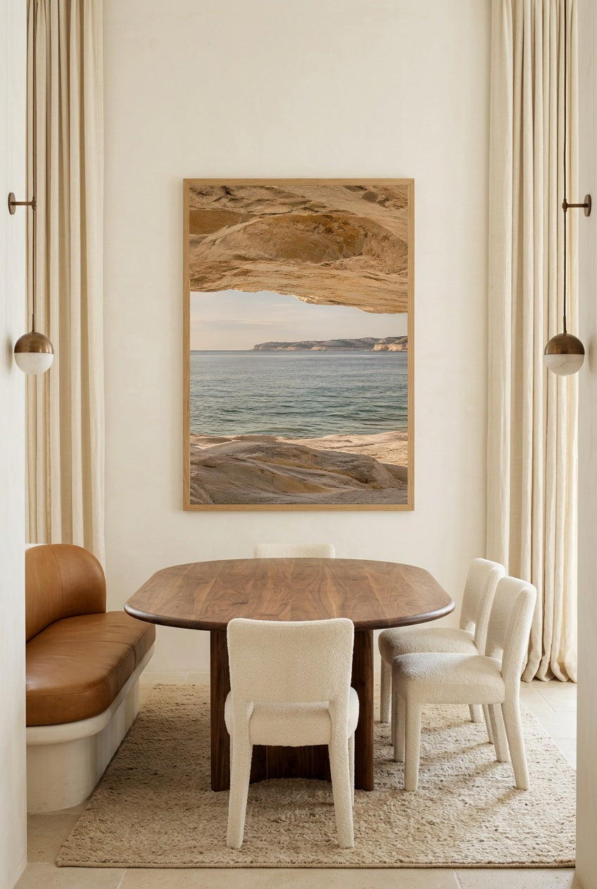 The Horizon beneath the Rock — poster in an oak frame above a dining table