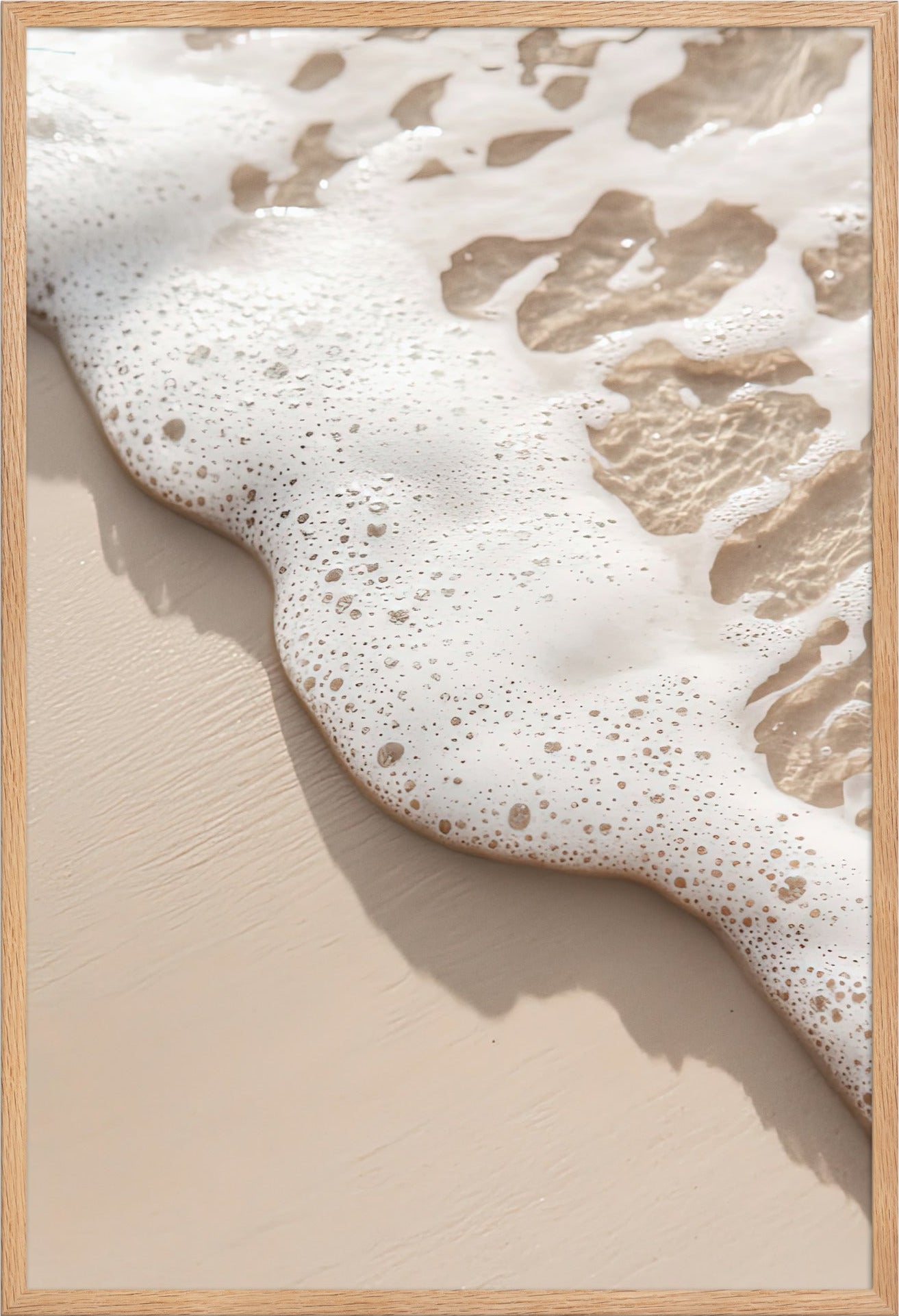 The Wave’s Edge poster in a solid oak frame — foam and pearly bubbles on ivory sand