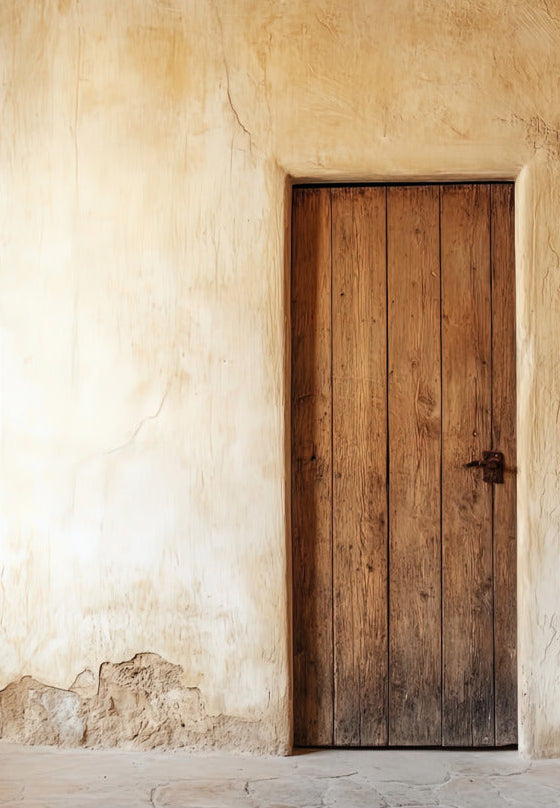 The Andalusian Door poster on 189 g/m² matte paper — warm wood door on a cracked ivory plaster wall
